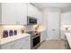 A kitchen featuring white cabinets, stainless steel appliances, and sleek countertops at 7407 S Blue Sage, Punta Gorda, FL 33955