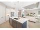 A modern kitchen with white cabinets, stainless steel appliances, and an island that connects to the living space at 7407 S Blue Sage, Punta Gorda, FL 33955