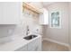 Well-lit laundry room equipped with a sink, countertop, and ample cabinet space at 7407 S Blue Sage, Punta Gorda, FL 33955