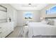 Bright main bedroom featuring a ceiling fan, window and ensuite bathroom at 7407 S Blue Sage, Punta Gorda, FL 33955