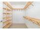 Walk-in closet with wooden shelving and minimalist decor at 7407 S Blue Sage, Punta Gorda, FL 33955