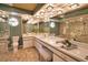 Bright bathroom features dual sinks, mirrors, and a glass enclosed shower at 7941 Pineglen Ct # 37, Sarasota, FL 34238