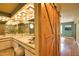 Bright bathroom featuring dual sinks, mirrors and wood barn door at 7941 Pineglen Ct # 37, Sarasota, FL 34238