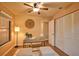 Charming bedroom with ceiling fan, large window, ample closet space, and a stylish work area at 7941 Pineglen Ct # 37, Sarasota, FL 34238