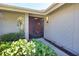 Inviting front entrance with a screen door, surrounded by lush greenery and mature landscaping at 7941 Pineglen Ct # 37, Sarasota, FL 34238