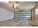 Empty two car garage with a concrete floor and an automatic door opener at 7941 Pineglen Ct # 37, Sarasota, FL 34238