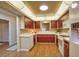 Charming kitchen featuring cherry cabinets and lots of counter space with modern lighting at 7941 Pineglen Ct # 37, Sarasota, FL 34238