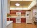 Cozy kitchen with lots of cabinet space, white appliances, and a view of the dining room at 7941 Pineglen Ct # 37, Sarasota, FL 34238