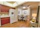 Kitchen features wood floors, a refrigerator, a dining nook, and cabinets and countertop space at 7941 Pineglen Ct # 37, Sarasota, FL 34238
