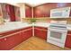 Charming kitchen featuring cherry cabinets, white countertops, and modern appliances at 7941 Pineglen Ct # 37, Sarasota, FL 34238