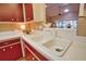 Bright kitchen sink area with modern faucet and white cabinets at 7941 Pineglen Ct # 37, Sarasota, FL 34238