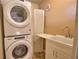Practical laundry area with a stacked washer and dryer and white folding table at 7941 Pineglen Ct # 37, Sarasota, FL 34238