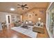 Spacious living room featuring a fireplace, vaulted ceiling, fan, and stylish neutral-toned furniture at 7941 Pineglen Ct # 37, Sarasota, FL 34238
