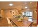 Bright living area featuring a fireplace, vaulted ceiling, fan, and seamless access to a patio at 7941 Pineglen Ct # 37, Sarasota, FL 34238