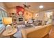 Cozy living room with a stone fireplace, fan, vaulted ceiling, and stylish neutral-toned furniture at 7941 Pineglen Ct # 37, Sarasota, FL 34238
