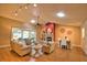 Bright living room featuring a fireplace, vaulted ceiling, fan, and seamless access to a patio at 7941 Pineglen Ct # 37, Sarasota, FL 34238