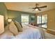 Bright main bedroom features sliding glass doors and ceiling fan at 7941 Pineglen Ct # 37, Sarasota, FL 34238