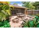 Outdoor patio includes a wooden deck, tropical foliage and a dining set at 7941 Pineglen Ct # 37, Sarasota, FL 34238