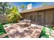 Inviting outdoor patio features a dining table with four chairs and screened sunroom at 7941 Pineglen Ct # 37, Sarasota, FL 34238