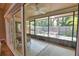 Relaxing screened patio with ceiling fan and furniture overlooks a lush backyard at 7941 Pineglen Ct # 37, Sarasota, FL 34238