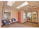Bright sunroom with skylights and sliding glass doors leading to laundry and views of dining room at 7941 Pineglen Ct # 37, Sarasota, FL 34238