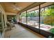 Relaxing sunroom with ceiling fan and view of fenced backyard at 7941 Pineglen Ct # 37, Sarasota, FL 34238