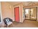 Sunroom features an exterior door, a chair, and large sliding doors giving way to the laundry and dining room at 7941 Pineglen Ct # 37, Sarasota, FL 34238