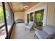 Relaxing sunroom features neutral furniture, sliding glass doors and breezy ceiling fan at 7941 Pineglen Ct # 37, Sarasota, FL 34238