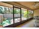 Covered sunroom with outdoor seating and view of the fenced yard at 7941 Pineglen Ct # 37, Sarasota, FL 34238