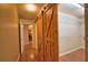 Walk-in closet with sliding barn door and built-in shelving at 7941 Pineglen Ct # 37, Sarasota, FL 34238