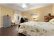 Well-lit bedroom featuring wood floors, a ceiling fan, and a workspace area at 867 Country Club Cir #71, Venice, FL 34293