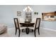 Cozy dining room with seating for four and chandelier lighting at 867 Country Club Cir #71, Venice, FL 34293