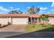 Charming single-story home featuring a well-maintained lawn, mature landscaping, and a private driveway leading to an attached garage at 867 Country Club Cir #71, Venice, FL 34293