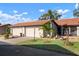 Charming single Gathering home with a two-car garage, concrete driveway and well-manicured front yard at 867 Country Club Cir #71, Venice, FL 34293