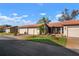 Inviting single-story home features lush lawn, mature landscaping, a private driveway, and an attached garage at 867 Country Club Cir #71, Venice, FL 34293