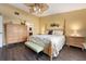 Spacious main bedroom boasts a ceiling fan, wood floors, and an ensuite bath at 867 Country Club Cir #71, Venice, FL 34293