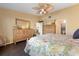 Bright main bedroom with wood-look floors and a glimpse into the attached bathroom at 867 Country Club Cir #71, Venice, FL 34293