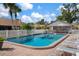 Relax by the sparkling pool surrounded by lush landscaping and lounge chairs at 867 Country Club Cir #71, Venice, FL 34293