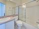 Bathroom featuring shower-tub combination with glass door, toilet, and vanity at 904 Harbor Town Dr, Venice, FL 34292