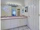 Bathroom with double sinks and white cabinets offering ample storage at 904 Harbor Town Dr, Venice, FL 34292