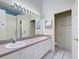Clean bathroom with double sinks and plenty of lighting and storage at 904 Harbor Town Dr, Venice, FL 34292