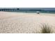 Expansive beach view with fishing pier in the distance at 904 Harbor Town Dr, Venice, FL 34292