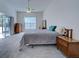 Bright bedroom featuring neutral gray carpet, white walls, and natural lighting at 904 Harbor Town Dr, Venice, FL 34292