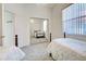 Bright bedroom with two twin beds, neutral walls, and a mirrored closet door at 904 Harbor Town Dr, Venice, FL 34292