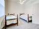 Bright bedroom featuring twin beds, neutral walls, and door to hallway at 904 Harbor Town Dr, Venice, FL 34292