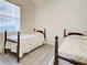 Bright bedroom featuring twin beds, neutral walls, and natural light from window at 904 Harbor Town Dr, Venice, FL 34292