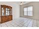 Bright dining area with tiled floors, enhanced by a window and decorative cabinet at 904 Harbor Town Dr, Venice, FL 34292