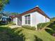 Rear exterior showcasing the tile roof and lush backyard of the property at 904 Harbor Town Dr, Venice, FL 34292