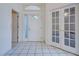 Bright foyer with white tile flooring, large windows and white doors at 904 Harbor Town Dr, Venice, FL 34292