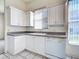 Clean kitchen boasts white cabinets, ample counter space, and natural light at 904 Harbor Town Dr, Venice, FL 34292